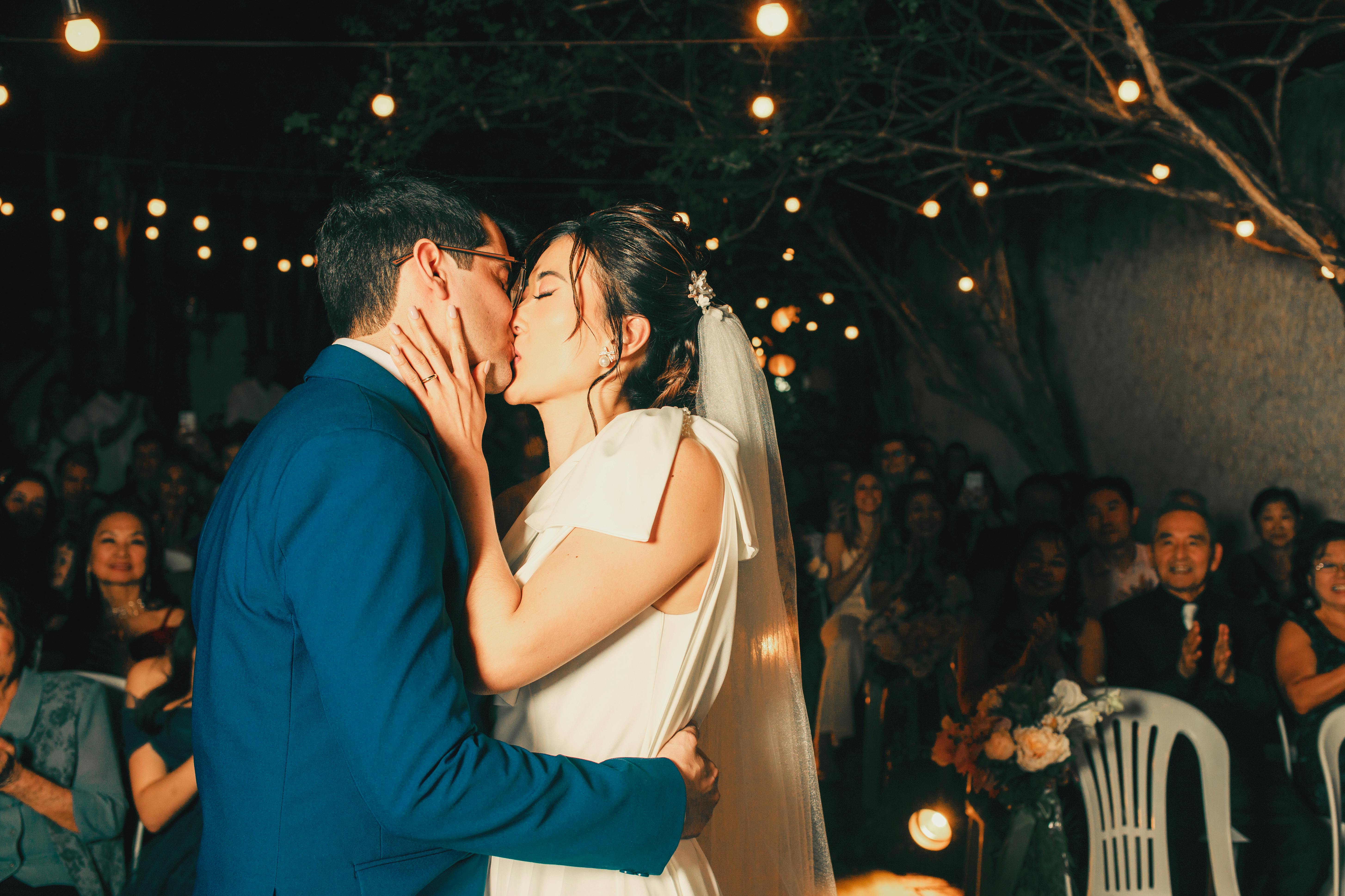 Bride and groom sharing their first kiss